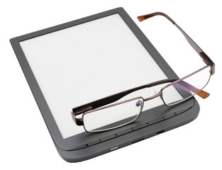 The glasses are lying on the book reader