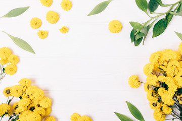 Festive floral flat lay frame of yellow flowers
