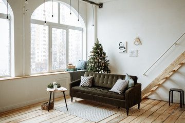 Bright living room with large Windows and Christmas tree decorated for Christmas
