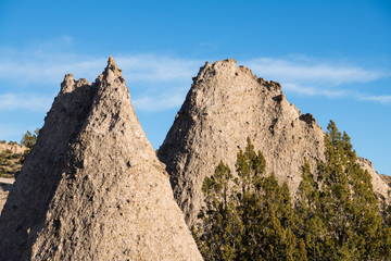 Sharp peaks of two highly textured rock formations at Kasha-Katuwe Tent Rocks National Monument, New Mexico