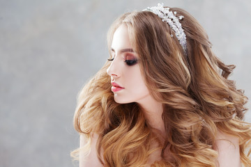Charming young bride with luxury hairstyle. Beautiful woman in wedding dress. Hairstyle with fluffy curls. © Ulia Koltyrina