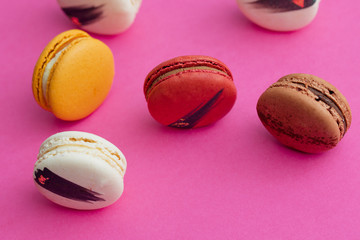 Elegant French desserts. Set of colorful macaron decorated by confectionery colours and toppings.