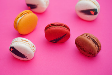 Elegant French desserts. Set of colorful macaron decorated by confectionery colours and toppings.