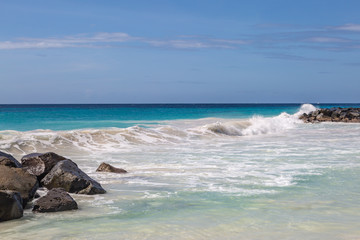 Waves crashing over rocks on a Caribbean Beach