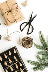 Christmas, New Year gifts packaging. Holiday composition with decorations and fir branches on white background. Flat lay, top view.