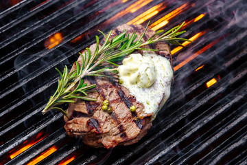steak on a grill fire, with herbs and butter © dimaris