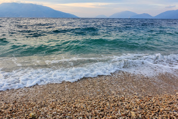 Gentle sea surf on a beach of pebbles on the shore