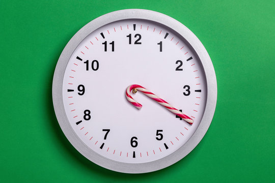 Christmas clock with candy cane hands shows four o'clock