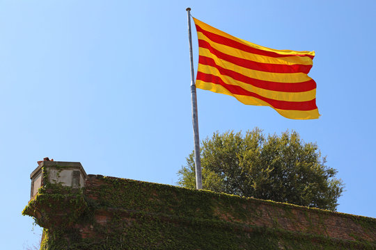 Flag of Catalonia on Montjuic castle, Barcelona, Spain