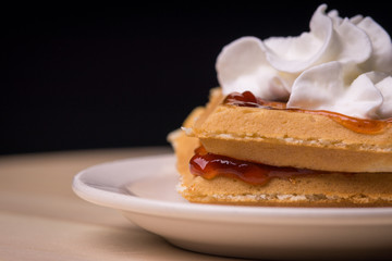 Waffles with jelly, syrup and whipped cream