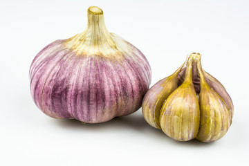 Two heads of garlic isolated on a white background.