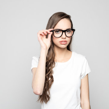 Portrait of beautiful teenager girl wearing nerd glasses