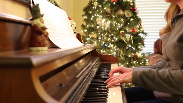 Woman Playing Piano at Christmas