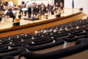 concert hall seats rows with musicians practicing