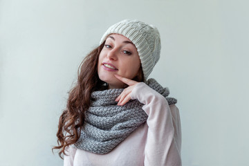 Beautiful woman winter portrait, true emotions. Laughing girl with long hair wearing warm clothes hat scarf isolated on white background. Young hipster girl looking happy and excited, having fun