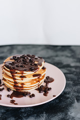 Stack of delicious homemade pancakes with sauce
