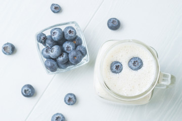 Blueberry smoothies on a light background, top view