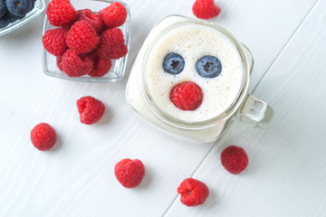 Blueberry and raspberry smoothies on a light background, top view