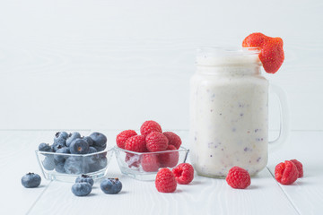 Blueberry and raspberry smoothies on a light background