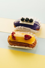 Set of delicious eclairs with glaze, colorful dessert