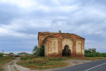 Fototapeta na wymiar Old abandoned brick church of the Nativity of Christ, located in the village of Stuzhen, Manturovsky district, Kursk region, Russia.