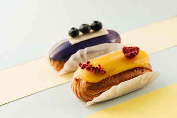 Set of delicious eclairs with glaze, colorful dessert