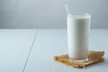 Full glass of milk on a white background, side view