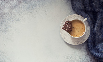Christmas background with cup of coffee, chocolate cookies and knitting pullover