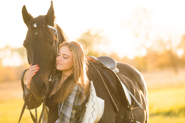 Girl equestrian rider stands near the horse. Horse farm. Horse theme 