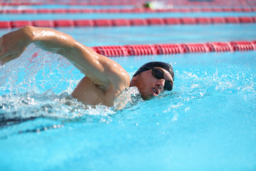 Swim athlete swimmer man training for triathlon race competition in outdoor swimming pool at...