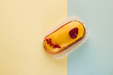 Delicious eclair with yellow glaze, sweet dessert