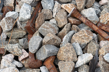 Macro rusty railroad spikes and granite gravel 1