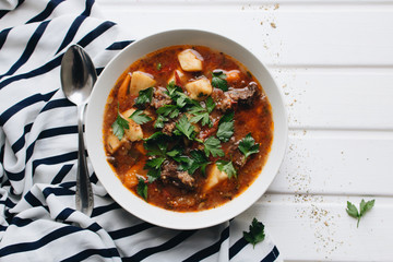Delicious tomato soup with parsley, meat and pepper
