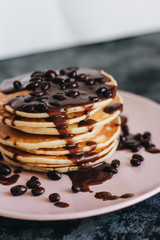 Stack of delicious homemade pancakes with sauce