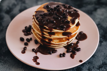 Stack of delicious homemade pancakes with sauce
