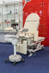 gynecological chair and other medical equipment in a gynecological office. vertical photo