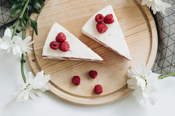 Two pieces of delicious cake with raspberries, sweet dessert