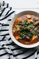 Delicious tomato soup with parsley, meat and pepper