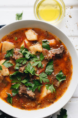Delicious tomato soup with parsley, meat and pepper
