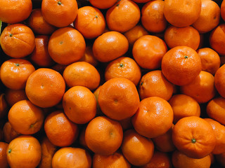 Pile of fresh mandarins, food background
