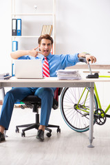 Young businessman using bike to commute to the office