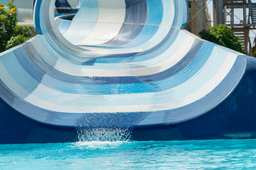 Obraz na płótnie Canvas Wide blue water slide in the water park.