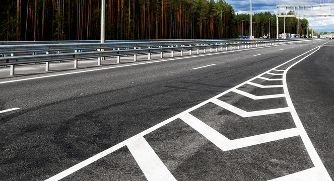 White road lines on the highway in sunny day