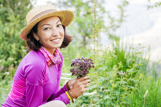 Woman Picking Oregano Healing Herbs As Medicine Outdoors