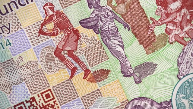 Nigeria 100 naira (2014) banknote rotating, Nigerian money close up. Traditional african dancers. 4K UHD video footage