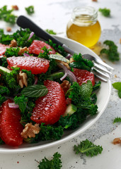 Healthy vegan food, vegetarian Grapefruit kale salad with walnuts, red onion and cucumber