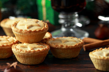 British Christmas mince pies with decoration, gifts, green tree branch on wooden rustic table © grinchh