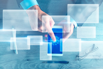 Business man hands with mobile and virtual screens. Concept of finance, business and technology