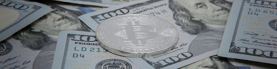coins of the bitcoin against the background of dollar notes. bitcoin the most Popular cryptocurrency in the world