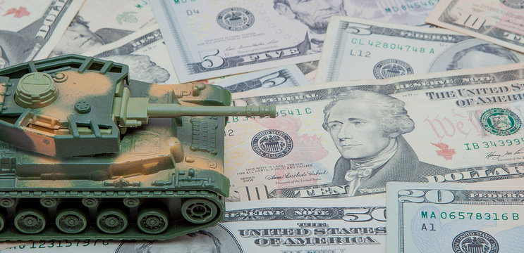 tank against the background of dollars. Concept of war